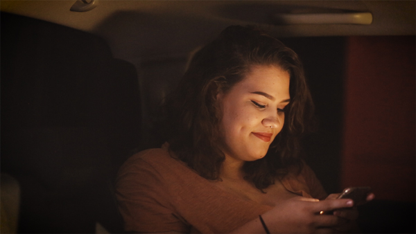 A man is behind the wheel of a speeding car at night.